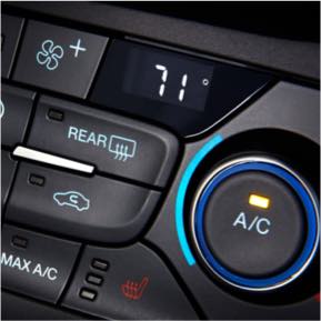 Air conditioning controls inside a vehicle.